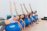 Portrait of class exercising on fitness balls