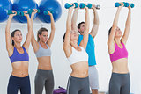 Fitness class exercising with dumbbells