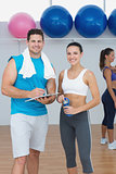 Couple with a woman in background at the gym