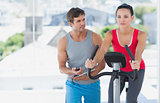 Male instructor working out at spinning class