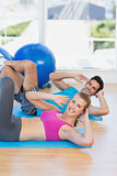 Portrait of a young couple exercising at gym