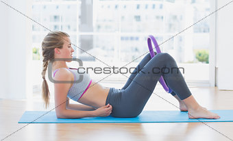 Sporty woman with exercising ring in fitness studio