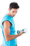 Serious young man exercising with dumbbell
