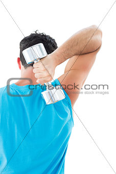 Rear view of a young man exercising with dumbbell