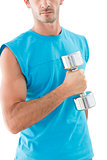 Mid section of a serious man exercising with dumbbell