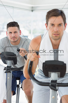 Determined man using exercise bike