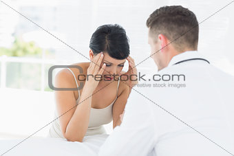 Stressed woman visiting doctor