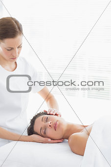 Physical therapist massaging woman