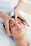 Woman having head massage in spa