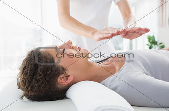 Woman having reiki treatment