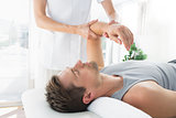 Man receiving hand massage from therapist