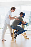 Female therapist massaging man in hospital
