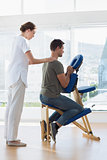 Physiotherapist massaging man in hospital