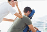 Therapist giving back massage to man