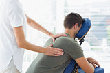 Physiotherapist giving massage to man