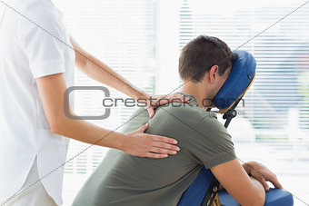 Physiotherapist giving massage to man