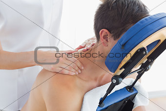 Man receiving massage by female therapist