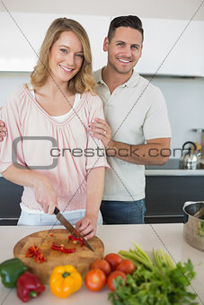 Couple preparing food together at kitchen counter
