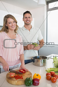 Couple cooking vegetables in kitchen