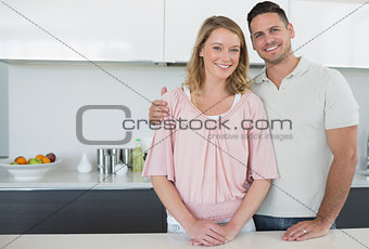Couple standing at kitchen counter