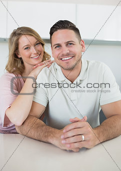Smiling young couple at kitchen counter