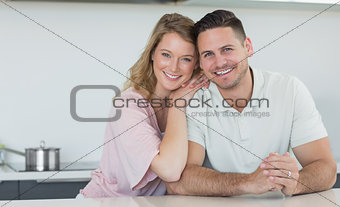 Couple smiling at kitchen counter