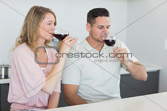 Couple drinking red wine at table