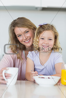 Mother and daughter having breakfast at home