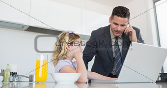 Daughter looking at father on call using laptop