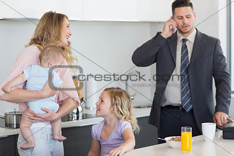 Family of four at breakfast table
