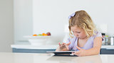 Girl touching digital tablet at table