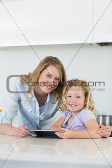 Mother and daughter with digital tablet