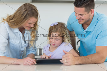 Family using tablet PC at table
