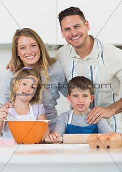 Family baking cookies at kitchen counter