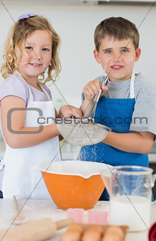 Children baking cookies together in kitchen