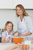 Mother and daughter making cookies