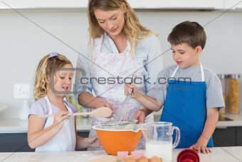 Children and mother baking cookies