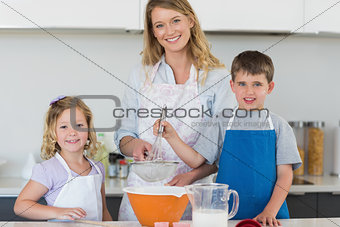 Family baking cookies at counter top
