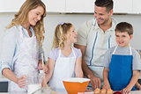 Family baking cookies together in kitchen