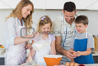 Family making cookies together in kitchen