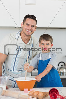 Father and son baking cookies together