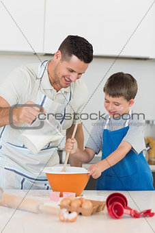 Father baking cookies with son