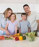 Loving family chopping vegetables in kitchen