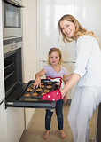 Woman baking cookies with daughter