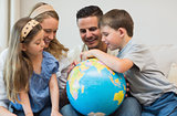 Family searching places on globe