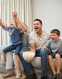 Family screaming while watching television