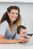Woman with baby using laptop