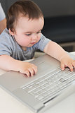 Baby using laptop at table