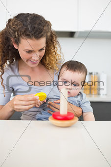 Mother with baby looking at toys