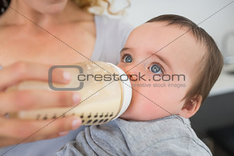 Mother feeding milk to baby